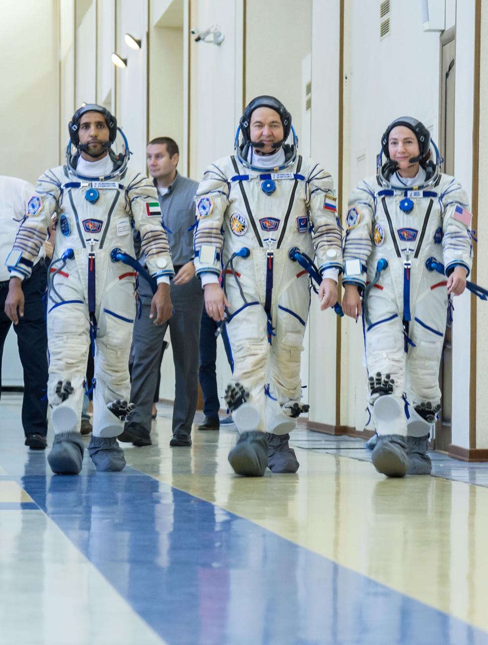 jsc2019e051856 - At the Gagarin Cosmonaut Training Center in Star City, Russia, spaceflight participant Hazzaa Ali Almansoori of the United Arab Emirates (left), Oleg Skripochka of Roscosmos (center) and Jessica Meir of NASA (right) report for duty on the second day of crew qualification exams Aug. 30. They will launch Sept. 25 on the Soyuz MS-15 spacecraft from the Baikonur Cosmodrome in Kazakhstan for a mission on the International Space Station...NASA/Beth Weissinger.