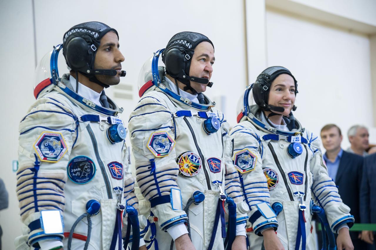 jsc2019e051860 - At the Gagarin Cosmonaut Training Center in Star City, Russia, spaceflight participant Hazzaa Ali Almansoori of the United Arab Emirates (left), Oleg Skripochka of Roscosmos (center) and Jessica Meir of NASA (right) report for duty on the second day of crew qualification exams Aug. 30. They will launch Sept. 25 on the Soyuz MS-15 spacecraft from the Baikonur Cosmodrome in Kazakhstan for a mission on the International Space Station...NASA/Beth Weissinger.