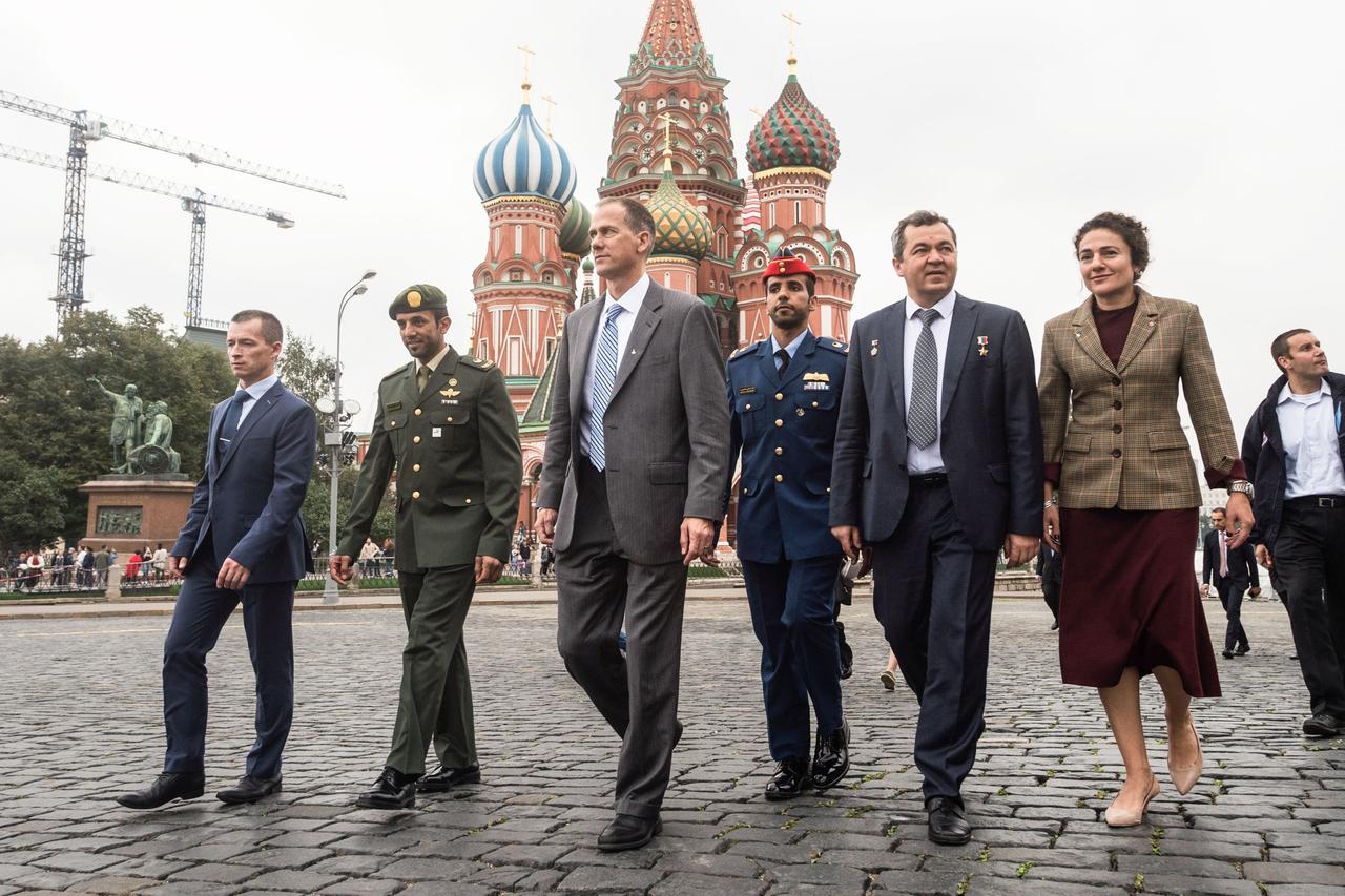 jsc2019e052236 - With St. Basil’s Cathedral serving as a backdrop, the next crew to launch to the International Space Station and their backups walk through Red Square in Moscow Sept. 5 as part of traditional pre-launch activities. From right to left are Expedition 61 crewmembers Jessica Meir of NASA and Oleg Skripochka of Roscosmos, spaceflight participant Hazzaa Ali Almansoori of the United Arab Emirates and backups, Tom Marshburn of NASA, Sultan Al-Neyadi of the United Arab Emirates and Sergey Ryzhikov of Roscosmos. Meir, Skripochka and Almansoori will launch Sept. 25 from the Baikonur Cosmodrome in Kazakhstan on the Soyuz MS-15 spacecraft for a mission on the International Space Station...Andrey Shelepin/Gagarin Cosmonaut Training Center.