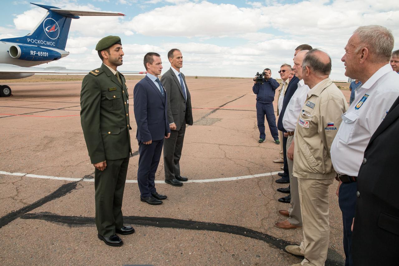 jsc2019e052744 - At the airport in Baikonur, Kazakhstan, backup crewmembers Sultan Al-Neyadi of the United Arab Emirates (left) who is a spaceflight participant and Expedition 61 backups Sergey Ryzhikov of Roscosmos (center) and Tom Marshburn of NASA (right) report to Russian space officials Sept. 10 upon their arrival at their launch site. They are the backups to the prime crew, spaceflight participant Hazzaa Ali Almansoori of the United Arab Emirates and Expedition 61 crewmembers Oleg Skripochka of Roscosmos and Jessica Meir of NASA, who will launch on Sept. 25 from the Baikonur Cosmodrome on the Soyuz MS-15 spacecraft for a mission on the International Space Station...NASA/Victor Zelentsov