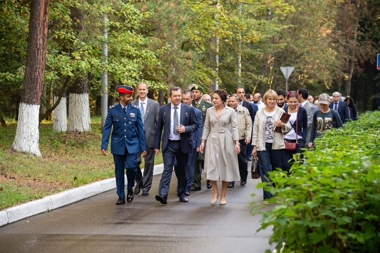jsc2019e052746 - At the Gagarin Cosmonaut Training Center in Star City, Russia, spaceflight participant Hazzaa Ali Almansoori of the United Arab Emirates (front, left) and Expedition 61 crewmembers Oleg Skripochka of Roscosmos (center) and Jessica Meir of NASA (right) lead the way Sept. 10 as they walk to the busses that will take them to a nearby airfield for a flight to their launch site at the Baikonur Cosmodrome in Kazakhstan. They will launch on Sept. 25 from the Baikonur Cosmodrome on the Soyuz MS-15 spacecraft for a mission on the International Space Station...NASA/Beth Weissinger