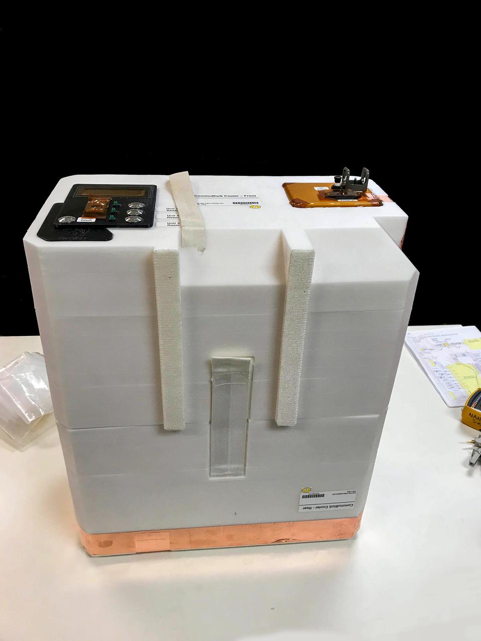 jsc2019e052824 (8/23/2019) --- Preflight view of the CommuBioS Payload Enclosure. Complex Micro(?)-Biological System (CommuBioS) studies the aging of complex multicomponent liquids during long-term storage in space. It stores samples of wine, a chemically complex liquid, on the space station and compares the samples with those stored in an aging facility on the ground to determine the effect of the space environment on specific components. Results advance knowledge of the evolution of compounds that are critical for the nutrition and taste of foods. Image courtesy of: NanoRacks