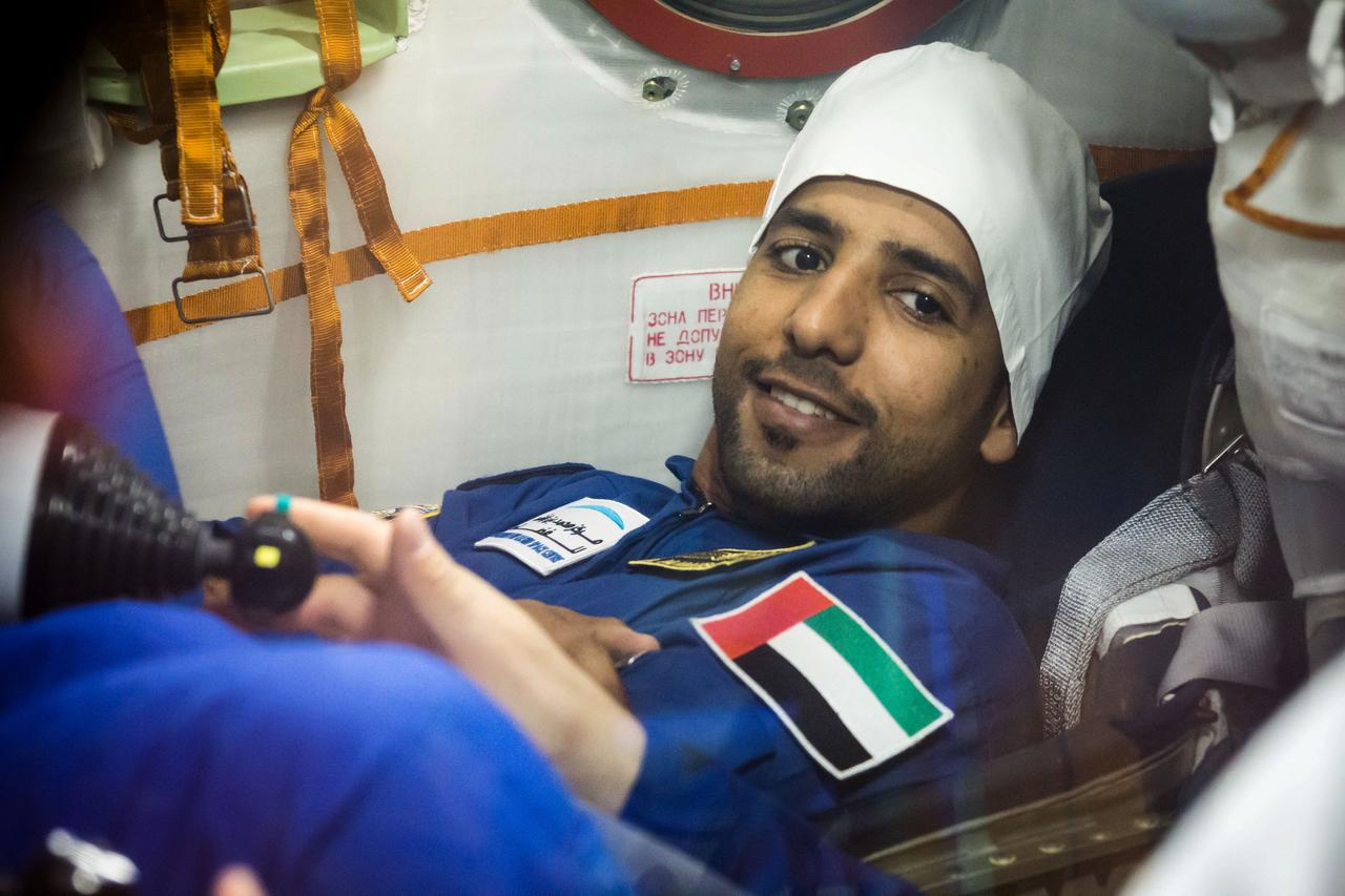 jsc2019e052881 - In the Integration Building at the Baikonur Cosmodrome in Kazakhstan, spaceflight participant Hazzaa Ali Almansoori of the United Arab Emirates runs through procedures Sept. 11 aboard the Soyuz MS-15 spacecraft during an initial Soyuz vehicle fit check. Almansoori, Oleg Skripochka of Roscosmos and Jessica Meir of NASA will launch Sept. 25 on the Soyuz MS-15 spacecraft from the Baikonur Cosmodrome for a mission on the International Space Station...NASA/Victor Zelentsov.