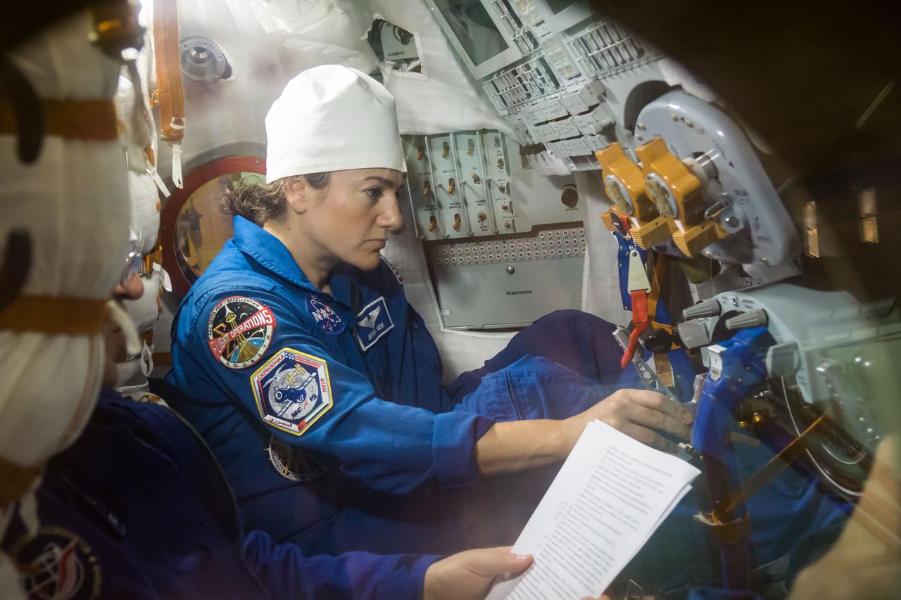 In the Integration Building at the Baikonur Cosmodrome in Kazakhstan, Expedition 61 crewmember Jessica Meir of NASA runs through procedures Sept. 11 aboard the Soyuz MS-15 spacecraft during an initial Soyuz vehicle fit check. Meir, spaceflight participant Hazzaa Ali Almansoori of the United Arab Emirates and Expedition 61 crewmember Oleg Skripochka of Roscosmos will launch Sept. 25 on the Soyuz MS-15 spacecraft from the Baikonur Cosmodrome for a mission on the International Space Station.  NASA/Victor Zelentsov 