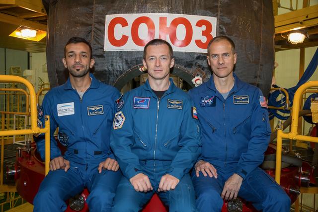 NASA image: jsc2019e052883 - In the Integration Building at the Baikonur Cosmodrome in Kazakhstan, backup spaceflight participant Sultan Al-Neyadi of the United Arab Emirates (left) and backup Expedition 61 crewmates Sergey Ryzhikov of Roscosmos (center) and Tom Mars