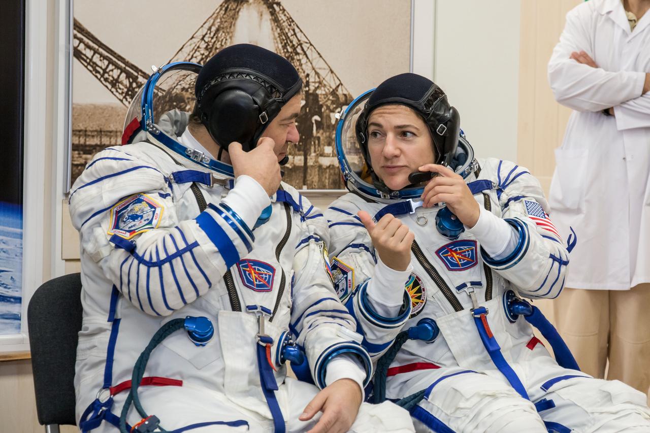 jsc2019e052888 - In the Integration Building at the Baikonur Cosmodrome in Kazakhstan, Expedition 61 crewmembers Oleg Skripochka of Roscosmos (left) and Jessica Meir of NASA (right) share some thoughts Sept. 11 during a portion of the initial fit check for their Soyuz MS-15 spacecraft. Along with spaceflight participant Hazzaa Ali Almansoori of the United Arab Emirates, they will launch Sept. 25 on the Soyuz MS-15 spacecraft from the Baikonur Cosmodrome for a mission on the International Space Station...NASA/Victor Zelentsov.