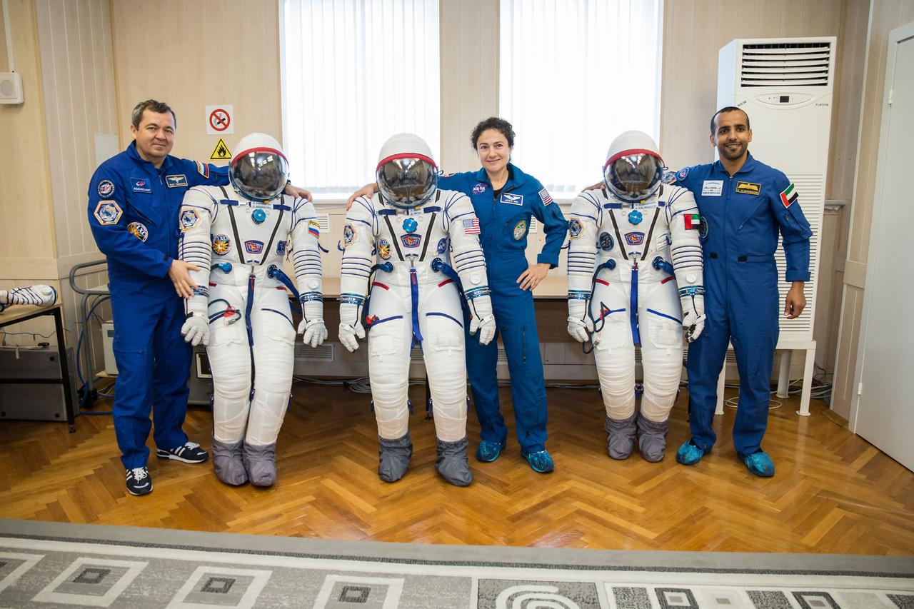In the Integration Building at the Baikonur Cosmodrome in Kazakhstan, Expedition 61 crewmembers Oleg Skripochka of Roscosmos (left) and Jessica Meir of NASA (center) and spaceflight participant Hazzaa Ali Almansoori of the United Arab Emirates pose for pictures with their Russian Sokol launch and entry suits Sept. 11. They will launch Sept. 25 on the Soyuz MS-15 spacecraft from the Baikonur Cosmodrome for a mission on the International Space Station. NASA/Victor Zelentsov