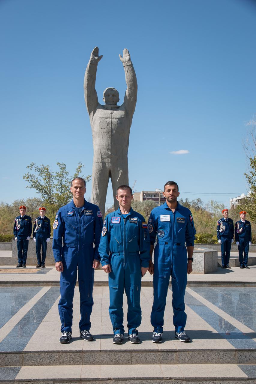 jsc2019e052904 - In the town of Baikonur, Kazakhstan, the backup crewmembers for the next launch to the International Space Station pose for pictures Sept. 12 in front of a statue of Yuri Gagarin, the first human to fly in space as part of traditional pre-launch activities. Backup spaceflight participant Sultan Al-Neyadi of the United Arab Emirates (left), Sergey Ryzhikov of Roscosmos (center) and Tom Marshburn of NASA (right) are the backups to the prime Expedition 61 crew, Oleg Skripochka of Roscosmos and Jessica Meir of NASA and spaceflight participant Hazzaa Ali Almansoori of the United Arab Emirates, who will launch Sept. 25 on the Soyuz MS-15 spacecraft for a mission on the International Space Station...NASA/Victor Zelentsov.