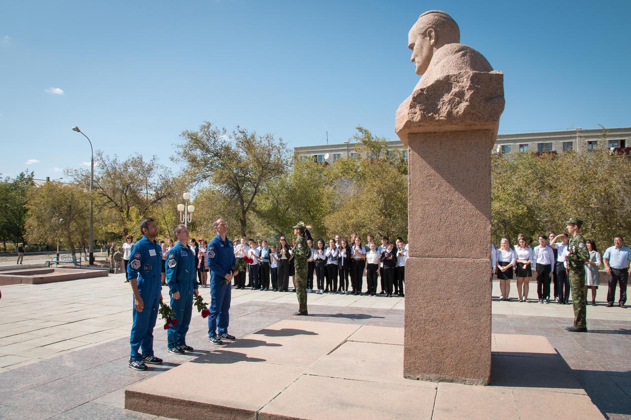 jsc2019e052905 - In the town of Baikonur, Kazakhstan, the backup crewmembers for the next launch to the International Space Station pay tribute Sept. 12 at a statue of Sergei Korolev, the Russian great designer, as part of traditional pre-launch activities. Backup spaceflight participant Sultan Al-Neyadi of the United Arab Emirates (left), Sergey Ryzhikov of Roscosmos (center) and Tom Marshburn of NASA (right) are the backups to the prime Expedition 61 crew, Oleg Skripochka of Roscosmos and Jessica Meir of NASA and spaceflight participant Hazzaa Ali Almansoori of the United Arab Emirates, who will launch Sept. 25 on the Soyuz MS-15 spacecraft for a mission on the International Space Station...NASA/Victor Zelentsov.