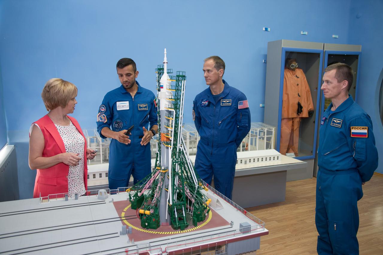 jsc2019e052907 - At the Baikonur Museum in the town of Baikonur, Kazakhstan, the backup crewmembers for the next launch to the International Space Station discuss the workings of a Soyuz launch pad Sept. 12 with a museum official during a traditional pre-launch tour. Spaceflight participant Sultan Al-Neyadi of the United Arab Emirates (left), Tom Marshburn of NASA (center) and Sergey Ryzhikov of Roscosmos (right) are the backups to the prime Expedition 61 crew, Oleg Skripochka of Roscosmos and Jessica Meir of NASA and spaceflight participant Hazzaa Ali Almansoori of the United Arab Emirates, who will launch Sept. 25 on the Soyuz MS-15 spacecraft for a mission on the International Space Station...NASA/Victor Zelentsov.