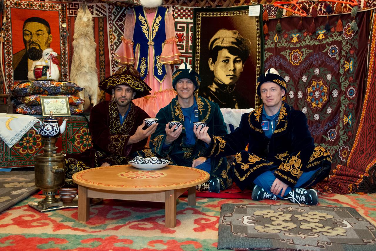 jsc2019e052908 - At the Baikonur Museum in the town of Baikonur, Kazakhstan, the backup crewmembers for the next launch to the International Space Station enjoy an afternoon cup of tea Sept. 12 in traditional Kazakh garb during a pre-launch tour. Spaceflight participant Sultan Al-Neyadi of the United Arab Emirates (left), Tom Marshburn of NASA (center) and Sergey Ryzhikov of Roscosmos (right) are the backups to the prime Expedition 61 crew, Oleg Skripochka of Roscosmos and Jessica Meir of NASA and spaceflight participant Hazzaa Ali Almansoori of the United Arab Emirates, who will launch Sept. 25 on the Soyuz MS-15 spacecraft for a mission on the International Space Station...NASA/Victor Zelentsov.