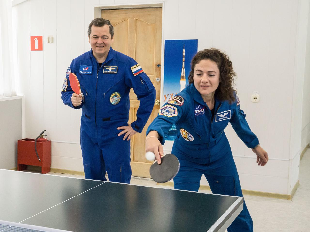 jsc2019e053720 - At the Cosmonaut Hotel crew quarters in Baikonur, Kazakhstan, Expedition 61 crewmembers Oleg Skripochka of Roscosmos (left) and Jessica Meir of NASA (right) share a game of ping-pong Sept. 18 as part of pre-launch activities. Along with spaceflight participant Hazzaa Ali Almansoori of the United Arab Emirates, they will launch Sept. 25 from the Baikonur Cosmodrome in Kazakhstan on the Soyuz MS-15 spacecraft for a mission on the International Space Station...NASA/Victor Zelentsov