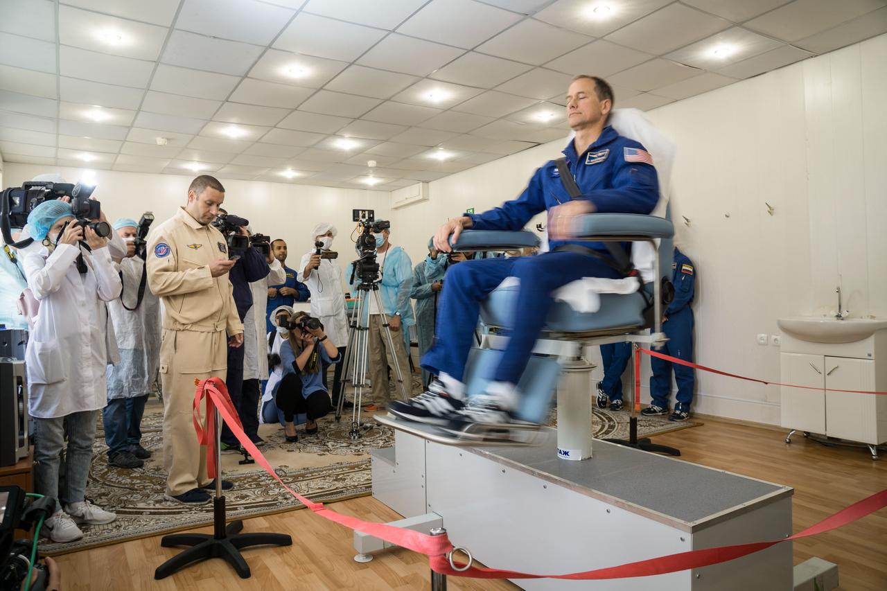 jsc2019e053722 - At the Cosmonaut Hotel crew quarters in Baikonur, Kazakhstan, backup Expedition 61 crewmember Tom Marshburn of NASA takes a spin in a rotating chair Sept. 18 to test his vestibular system as part of pre-launch activities. He is one of the backups to the prime crew, spaceflight participant Hazzaa ali Almansoori of the United Arab Emirates and Expedition 61 crewmembers Oleg Skripochka of Roscosmos and Jessica Meir of NASA, who are set to launch Sept. 25 from the Baikonur Cosmodrome in Kazakhstan on the Soyuz MS-15 spacecraft for a mission on the International Space Station...NASA/Victor Zelentsov