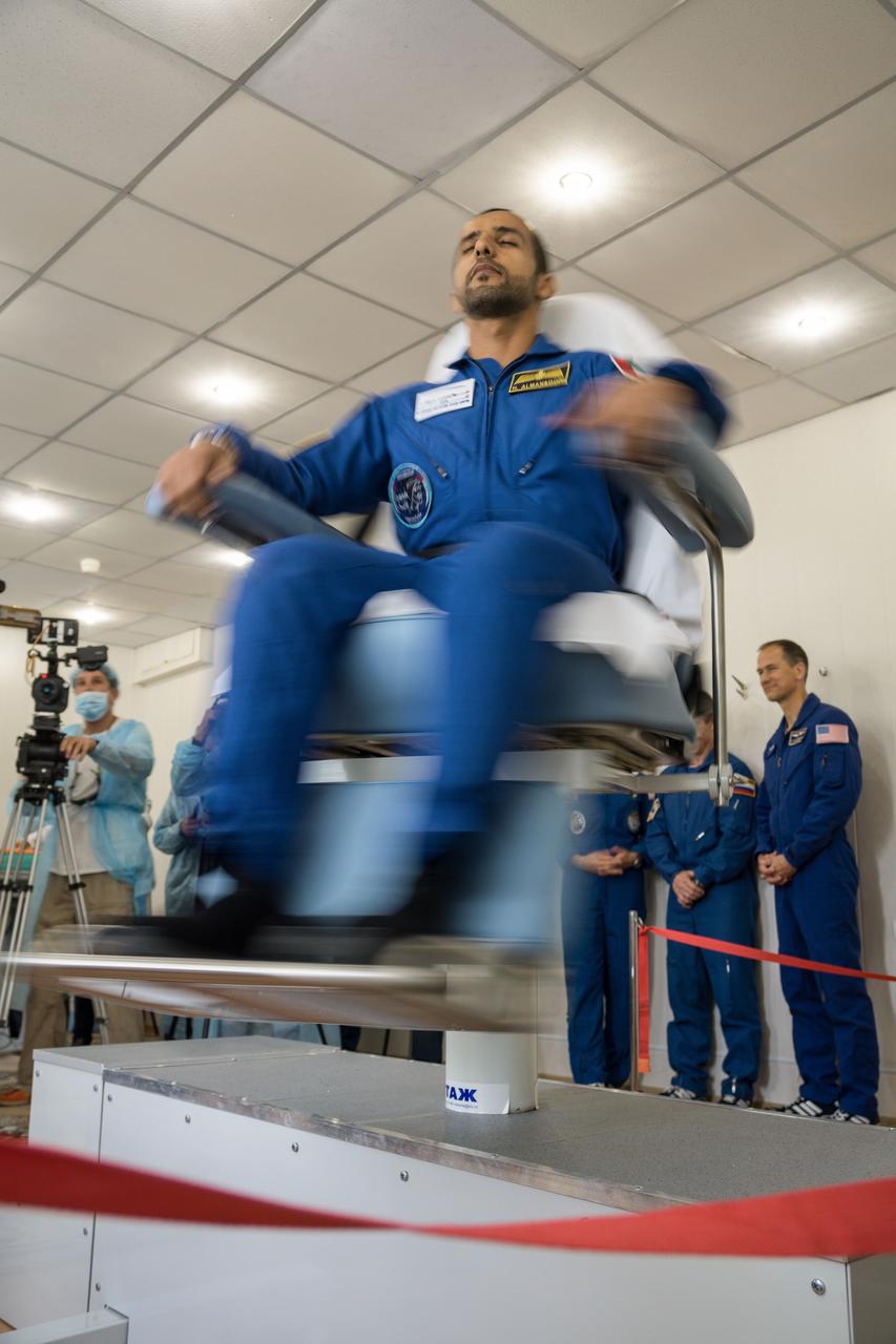 jsc2019e053723 - At the Cosmonaut Hotel crew quarters in Baikonur, Kazakhstan, spaceflight participant Hazzaa Ali Almansoori of the United Arab Emirates takes a spin in a rotating chair Sept. 18 to test his vestibular system as part of pre-launch activities. Along with Expedition 61 crewmembers Oleg Skripochka of Roscosmos and Jessica Meir of NASA, they will launch Sept. 25 from the Baikonur Cosmodrome in Kazakhstan on the Soyuz MS-15 spacecraft for a mission on the International Space Station...NASA/Victor Zelentsov