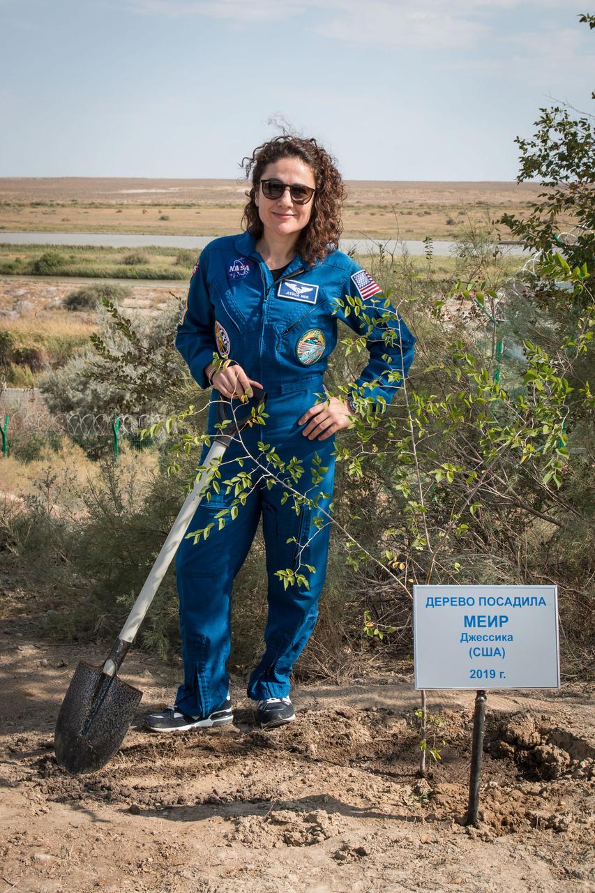 jsc2019e053727 - At the Cosmonaut Hotel crew quarters in Baikonur, Kazakhstan, Expedition 61 crewmember Jessica Meir of NASA poses for pictures Sept. 18 after planting a tree in her name in a traditional pre-launch activity. Meir and Expedition 61 crewmember Oleg Skripochka of Roscosmos along with spaceflight participant Hazzaa Ali Almansoori of the United Arab Emirates will launch Sept. 25 from the Baikonur Cosmodrome in Kazakhstan on the Soyuz MS-15 spacecraft for a mission on the International Space Station...NASA/Victor Zelentsov