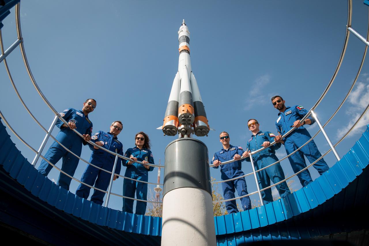 jsc2019e053728 - At the Cosmonaut Hotel crew quarters in Baikonur, Kazakhstan, the Expedition 61 prime and backup crewmembers and spaceflight participants pose for pictures Sept. 18 around a Soyuz rocket model as part of pre-launch activities. From left to right are the prime crewmembers, spaceflight participant Hazzaa Ali Almansoori of the United Arab Emirates and Expedition 61 crewmembers Oleg Skripochka of Roscosmos and Jessica Meir of NASA, and Expedition 61 backup crewmembers Tom Marshburn of NASA and Sergey Ryzhikov of Roscosmos and backup spaceflight participant Sultan Al-Neyadi of the United Arab Emirates. Meir, Skripochka and Almansoori will launch Sept. 25 from the Baikonur Cosmodrome in Kazakhstan on the Soyuz MS-15 spacecraft for a mission on the International Space Station...NASA/Victor Zelentsov