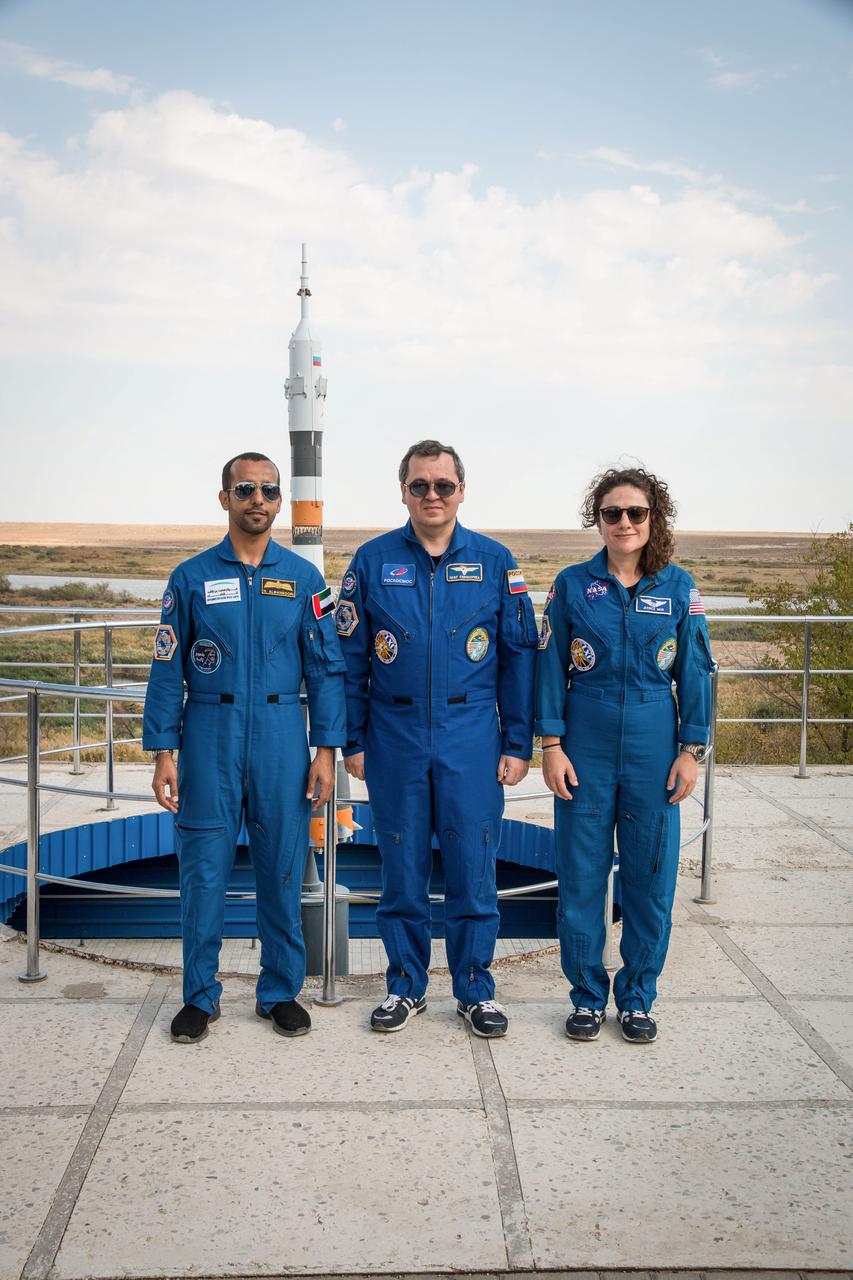 jsc2019e053729 - At the Cosmonaut Hotel crew quarters in Baikonur, Kazakhstan, spaceflight participant Hazzaa Ali Almansoori of the United Arab Emirates (left) and Expedition 61 crewmembers Oleg Skripochka of Roscosmos (center) and Jessica Meir of NASA (right) pose for pictures Sept. 18 as part of pre-launch activities. They will launch Sept. 25 from the Baikonur Cosmodrome in Kazakhstan on the Soyuz MS-15 spacecraft for a mission on the International Space Station...NASA/Victor Zelentsov