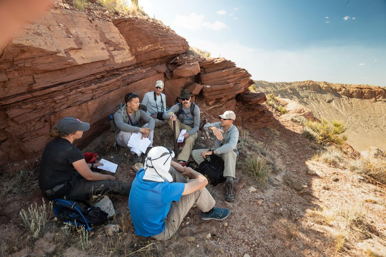 jsc2019e055491 (09-19-19) --- 2017 NASA astronaut candidates gather to discuss further instruction with their field instructor during geology training in Arizona. Photo Credit: (NASA/Bill Stafford)