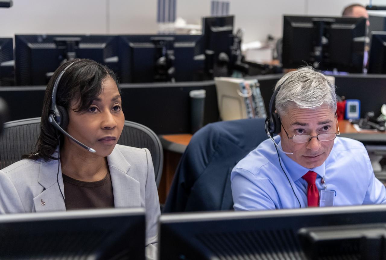 jsc2019e060008 (Oct. 18, 2019) --- From the Mission Control Center in Houston, veteran NASA astronauts Stephanie Wilson and Mark Vande Hei are on the CAPCOM (capsule communicator) console monitoring the spacewalk being conducted by Expedition 61 Flight Engineers Christina Koch and Jessica Meir. Wilson provided robotic arm support maneuvering spacewalkers during the STS-120 and STS-131 space shuttle missions to the International Space Station. Vande Hei conducted four spacewalks totaling 26 hours and 42 minutes during his stay aboard the orbiting lab as an Expedition 53-54 Flight Engineer.