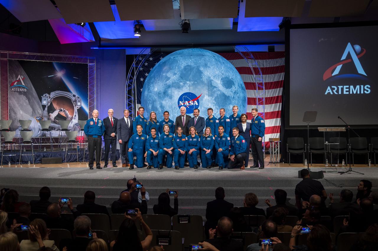 jsc2020e000653 (Jan. 10, 2020) --- The 2017 Class of Astronauts poses for a portrait with NASA officals and Texas Senators at the Johnson Space Center in Houston, Texas. In the front row (from left) are, NASA astronauts Jonny Kim, Jessica Watkins, Kayla Barron, Jasmin Moghbeli, Loral O'Hara, Zena Cardman and Raja Chari and Canadian Space Agency (CSA) astronaut Jeremy Hansen. In the back row (from left) are, Chief of the Astronuat Office Patrick Forrester, Johnson Space Center Director Mark Geyer, NASA Administrator Jim Bridenstine, Canadian Space Agency (CSA) astronauts Joshua Kutryk and Jennifer Sidey-Gibbon, NASA astronaut Frank Rubio, Senators John Cornyn and Ted Cruz, NASA astronauts Matthew Dominick, Bob Hines and Warren Hoburg, Johnson Space Center Deputy Director Vanessa Wyche and NASA astronaut Reid Wiseman.  This is the first class of astronauts to graduate under the Artemis program and are now eligible for assignments to the International Space Station, Artemis missions to the Moon, and ultimately, missions to Mars.