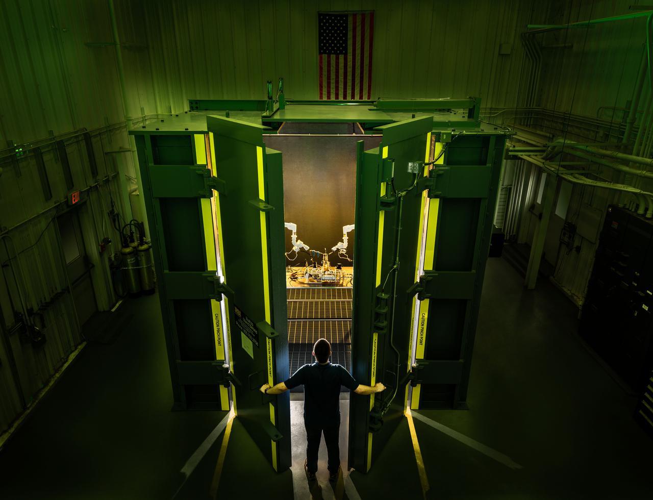 Test Engineer Chris McWilliams looks in on test equipment in the Boom Box High Pressure Test Enclosure in the Building 353H at Johnson Space Center’s Energy Systems Test Area.  Photo Date: January 16, 2020.  Photo Credit: (NASA/Robert Markowitz)