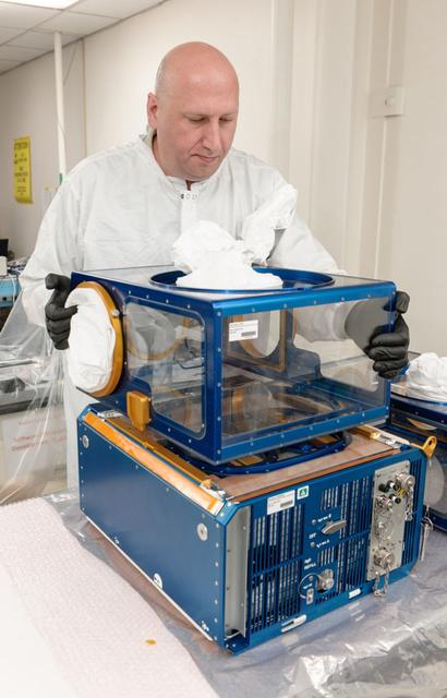 jsc2020e008566 (12/31/2013) --- Lockheed Martin engineer Robert Benzio conducts a fit check with two Rodent Research modules at NASA's Ames Research Center in Moffett Field, California. The Rodent Research Facility provides rodent housing on board the International Space Station (ISS). Animal research is essential for understanding the impacts of spaceflight on the systems of the human body, and for development of potential therapies that will ease harmful responses to space flight.   Credits: NASA/Dominic Hart