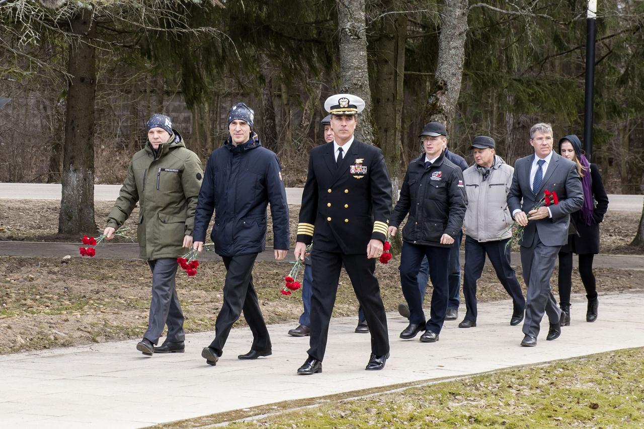 jsc2020e016841 - At the Gagarin Cosmonaut Training Center in Star City, Russia, Expedition 63 prime crewmembers Ivan Vagner (front left) and Anatoly Ivanishin (front center) of Roscosmos and NASA’s Chris Cassidy (front right) carry flowers March 23 to the statue of Yuri Gagarin, the first human to fly in space, as part of pre-launch activities. Behind them are the backup crewmembers, Andrey Babkin and Sergey Ryzhikov of Roscosmos and NASA’s Steve Bowen. Vagner, Ivanishin and Cassidy will launch April 9 on the Soyuz MS-16 spacecraft from the Baikonur Cosmodrome in Kazakhstan for a six-and-a-half month mission on the International Space Station...Irina Spector/Gagarin Cosmonaut Training Center.