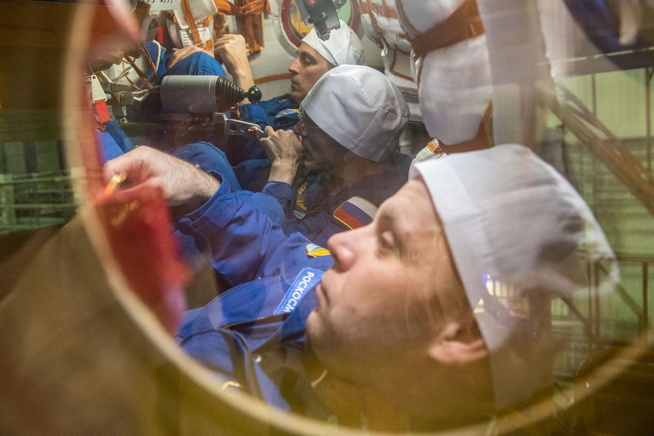 jsc2020e016848 - At the Baikonur Cosmodrome in Kazakhstan, Expedition 63 crewmembers Chris Cassidy of NASA (top) and Anatoly Ivanishin (center) and Ivan Vagner (bottom) of Roscosmos run through procedures during a pre-launch training session in the Soyuz MS-16 spacecraft March 25. They will launch April 9 on the Soyuz from Baikonur for a six-and-a-half month mission on the International Space Station...Andrey Shelepin/Gagarin Cosmonaut Training Center.