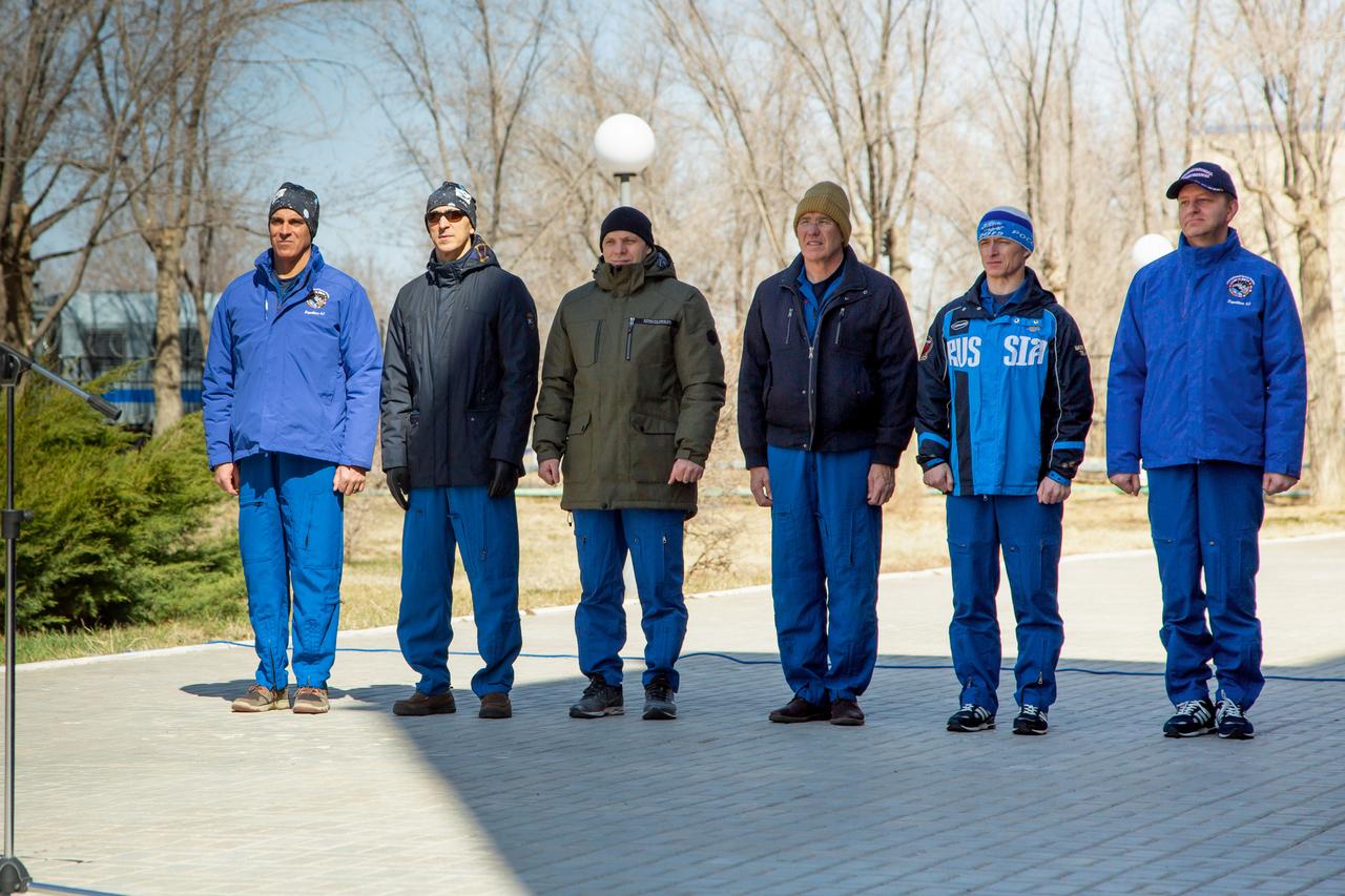 jsc2020e016868 - At the Cosmonaut Hotel crew quarters in Baikonur, Kazakhstan, the Expedition 63 prime and backup crews attend the traditional flag raising ceremony March 26 as part of their pre-launch activities. Seen from left to right are prime crewmembers Chris Cassidy of NASA, Anatoly Ivanishin and Ivan Vagner of Roscosmos and the backup crewmembers, Steve Bowen of NASA and Sergey Ryzhikov and Andrei Babkin of Roscosmos. Cassidy, Ivanishin and Vagner will launch April 9 from the Baikonur Cosmodrome on the Soyuz MS-16 spacecraft for a six-and-a-half month mission on the International Space Station...Courtesy/Roscosmos.