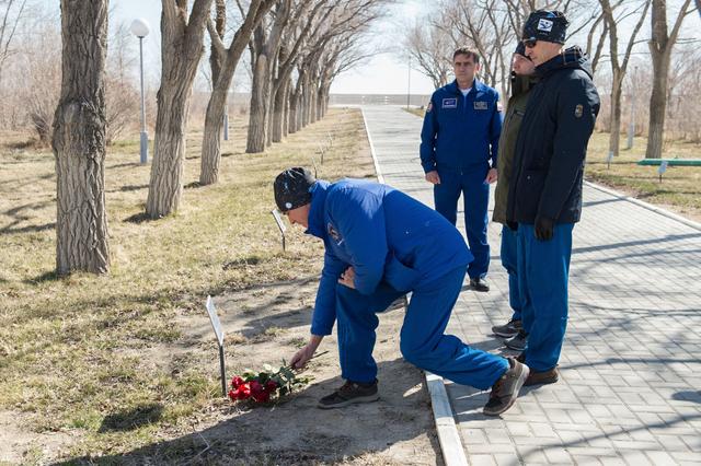 jsc2020e016869 - Along the Walk of the Cosmonauts at the Cosmonaut Hotel crew quarters in Baikonur, Kazakhstan, Expedition 63 crewmember Chris Cassidy of NASA lays flowers March 27 at the site where the tree bearing the name of Yuri Gagarin, the first human to fly in space, is planted. March 27, 2020 marked the 52nd anniversary of Gagarin’s death at the age of 34. Looking on are cosmonaut Yuri Malenchenko, the Deputy Director of the Gagarin Cosmonaut Training Center, and Cassidy’s crewmates, Ivan Vagner and Anatoly Ivanishin of Roscosmos. Cassidy, Vagner and Ivanishin will launch April 9 on the Soyuz MS-16 spacecraft from the Baikonur Cosmodrome in Kazakhstan for a six-and-a-half month mission on the International Space Station...Andrey Shelepin/Gagarin Cosmonaut Training Center.