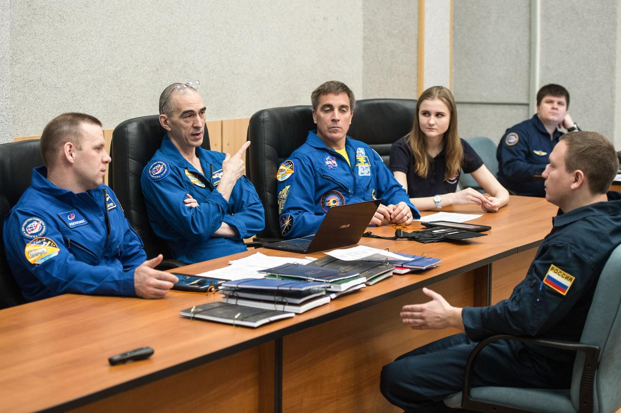jsc2020e016957 - At the Cosmonaut Hotel crew quarters in Baikonur, Kazakhstan, Expedition 63 crewmembers Ivan Vagner (left) and Anatoly Ivanishin (center) of Roscosmos and Chris Cassidy of NASA (right) review launch procedures with trainers April 1. They will launch April 9 on the Soyuz MS-16 spacecraft from the Baikonur Cosmodrome in Kazakhstan for a six-and-a-half month mission on the International Space Station...Andrey Shelepin/Gagarin Cosmonaut Training Center.