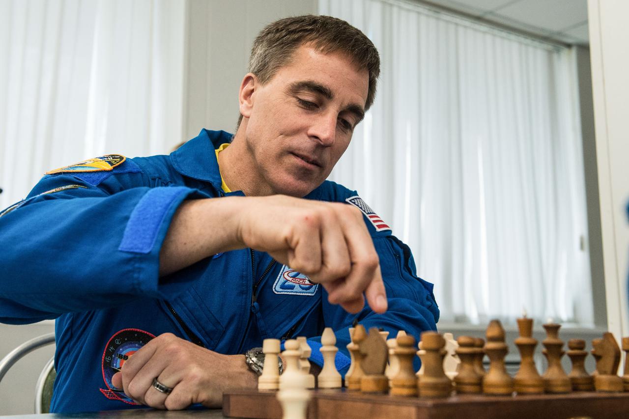jsc2020e016962 - At the Cosmonaut Hotel crew quarters in Baikonur, Kazakhstan, Expedition 63 crewmember Chris Cassidy of NASA plays a game of chess April 1. Cassidy and Ivan Vagner and Anatoly Ivanishin of Roscosmos will launch April 9 on the Soyuz MS-16 spacecraft from the Baikonur Cosmodrome in Kazakhstan for a six-and-a-half month mission on the International Space Station...Andrey Shelepin/Gagarin Cosmonaut Training Center.