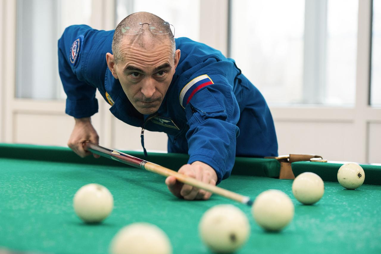 jsc2020e016964 - At the Cosmonaut Hotel crew quarters in Baikonur, Kazakhstan, Expedition 63 crewmember Anatoly Ivanishin of Roscosmos plays a game of billiards April 1. Ivanishin, Chris Cassidy of NASA and Ivan Vagner of Roscosmos will launch April 9 on the Soyuz MS-16 spacecraft from the Baikonur Cosmodrome in Kazakhstan for a six-and-a-half month mission on the International Space Station...Andrey Shelepin/Gagarin Cosmonaut Training Center.