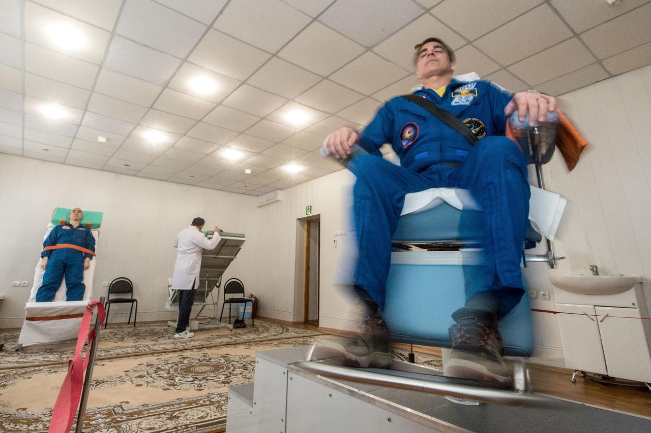 jsc2020e016967 - At the Cosmonaut Hotel crew quarters in Baikonur, Kazakhstan, Expedition 63 crewmembers Chris Cassidy of NASA (right) and Anatoly Ivanishin of Roscosmos (left) take a spin April 1 to test their vestibular systems as part of pre-launch training. Cassidy, Ivanishin and Ivan Vagner of Roscosmos will launch April 9 on the Soyuz MS-16 spacecraft from the Baikonur Cosmodrome in Kazakhstan for a six-and-a-half month mission on the International Space Station...Andrey Shelepin/Gagarin Cosmonaut Training Center.