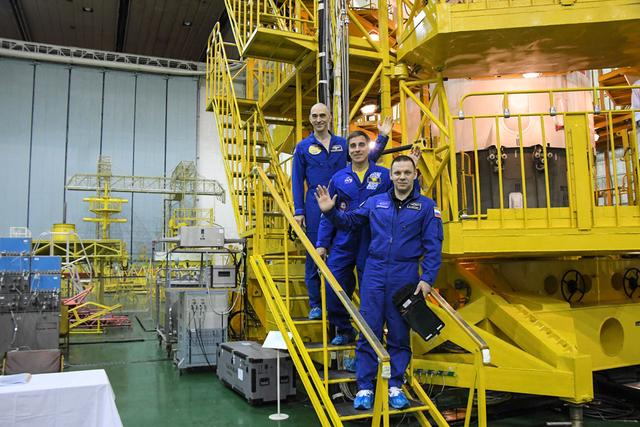 jsc2020e016983 - At the Baikonur Cosmodrome in Kazakhstan, Expedition 63 crewmembers Anatoly Ivanishin (top) of Roscosmos, Chris Cassidy (center) of NASA and Ivan Vagner (bottom) of Roscosmos pose for pictures April 3 in front of their Soyuz spacecraft as part of their pre-launch activities. They will launch April 9 on the Soyuz MS-16 spacecraft from Baikonur on April 9 for a six-and-a-half month mission on the International Space Station...Courtesy/Roscosmos.