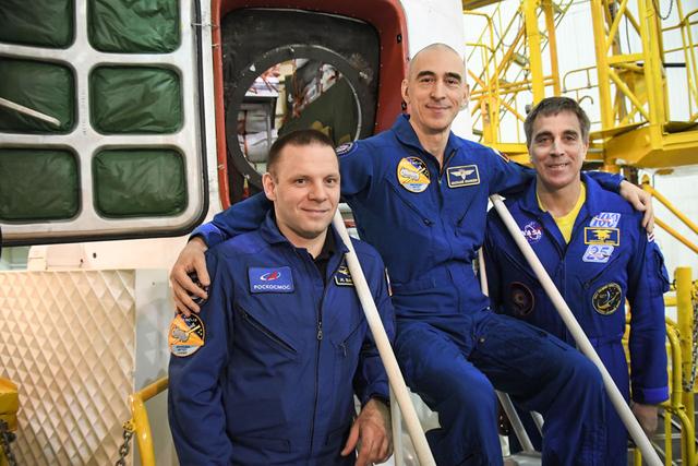 jsc2020e016985 - At the Baikonur Cosmodrome in Kazakhstan, Expedition 63 crewmembers Ivan Vagner (left) and Anatoly Ivanishin (center) of Roscosmos and Chris Cassidy (right) of NASA pose for pictures April 3 in front of their Soyuz spacecraft as part of their pre-launch activities. They will launch April 9 on the Soyuz MS-16 spacecraft from Baikonur on April 9 for a six-and-a-half month mission on the International Space Station...Courtesy/Roscosmos.