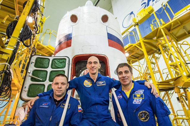 jsc2020e016986 - At the Baikonur Cosmodrome in Kazakhstan, Expedition 63 crewmembers Ivan Vagner (left) and Anatoly Ivanishin (center) of Roscosmos and Chris Cassidy (right) of NASA pose for pictures April 3 in front of their Soyuz spacecraft as part of their pre-launch activities. They will launch April 9 on the Soyuz MS-16 spacecraft from Baikonur on April 9 for a six-and-a-half month mission on the International Space Station...Courtesy/Roscosmos.
