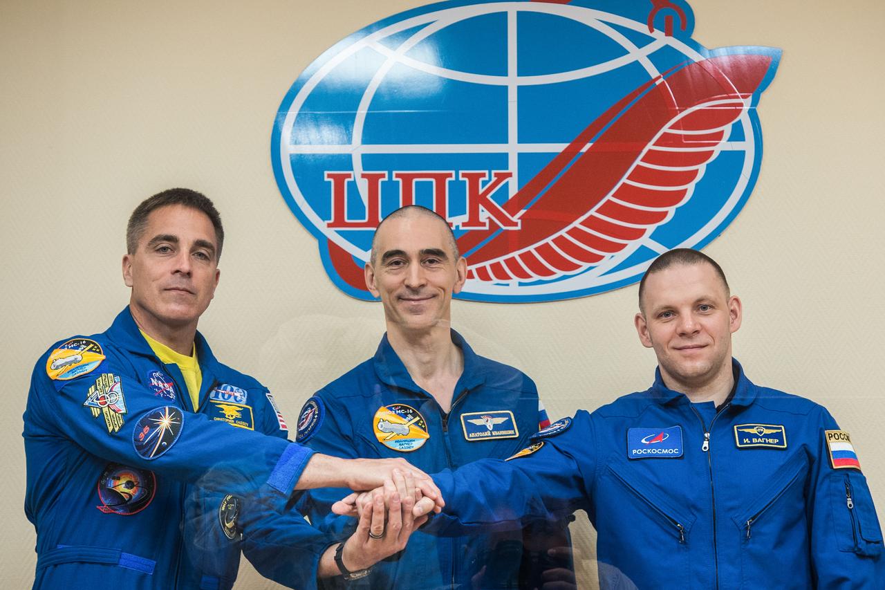 jsc2020e017047 - At the Cosmonaut Hotel crew quarters in Baikonur, Kazakhstan, Expedition 63 crewmembers Chris Cassidy of NASA (left) and Anatoly Ivanishin (center) and Ivan Vagner (right) of Roscosmos pose for pictures April 8 as they prepare for launch. They will launch April 9 on the Soyuz MS-16 spacecraft from the Baikonur Cosmodrome for a six-and-a-half month mission on the International Space Station...Andrey Shelepin/Gagarin Cosmonaut Training Center.