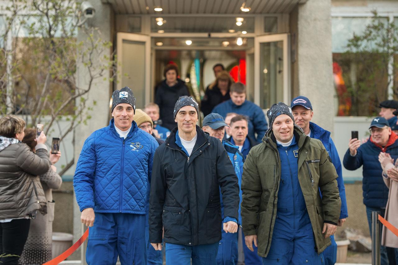 jsc2020e017065 - Expedition 63 Preflight - Expedition 63 crewmembers Chris Cassidy of NASA, left, and Anatoly Ivanishin, center, and Ivan Vagner of Roscosmos leave their Cosmonaut Hotel crew quarters in Baikonur, Kazakhstan to travel to their suit up facility for launch on the Soyuz MS-16 rocket from the Baikonur Cosmodrome, Thursday, April 9, 2020. They are beginning a six-and-a-half month mission on the International Space Station.Photo Credit: (NASA/GCTC/Andrey Shelepin)