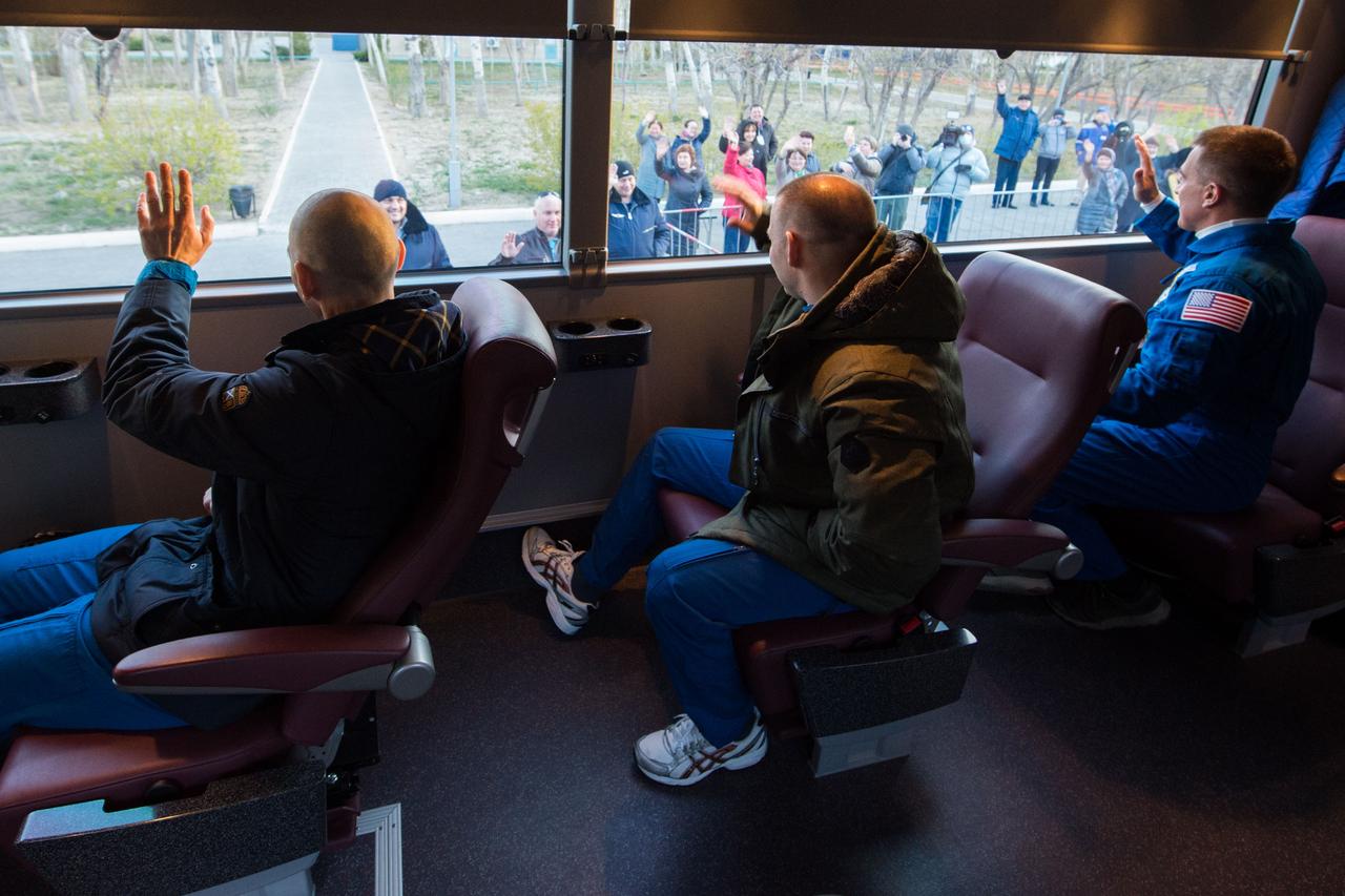 jsc2020e017068 - Expedition 63 Preflight - Expedition 63 crewmembers Anatoly Ivanishin, left, Ivan Vagner of Roscosmos, center, and Chris Cassidy of NASA, right, wave farewell as they depart their Cosmonaut Hotel crew quarters in Baikonur, Kazakhstan to travel to their suit up facility for launch on the Soyuz MS-16 rocket from the Baikonur Cosmodrome, Thursday, April 9, 2020. They are beginning a six-and-a-half month mission on the International Space Station. Photo Credit: (NASA/GCTC/Andrey Shelepin)