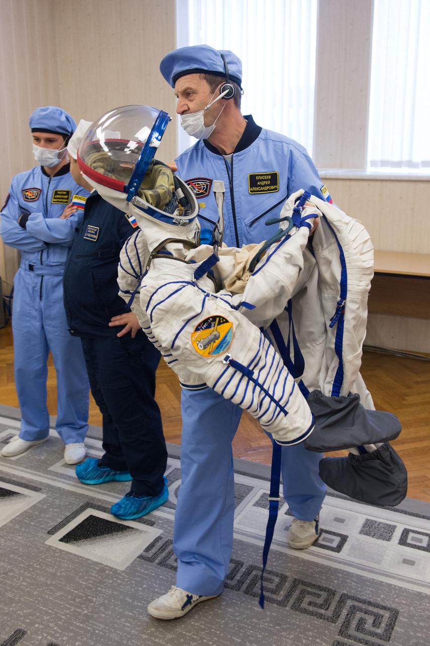 jsc2020e017076 - Expedition 63 Preflight- A technician prepares to help Expedition 63 crewmember Chris Cassidy of NASA don his Sokol Suit a few hours ahead of his launch on a Soyuz rocket with Ivan Vagner and Anatoly Ivanishin of Roscosmos, Thursday, April 9, 2020 at the Baikonur Cosmodrome in Kazakhstan. A few hours later, they lifted off for a six-and-a-half month mission on the International Space Station. Photo Credit: (NASA/GCTC/Andrey Shelepin)