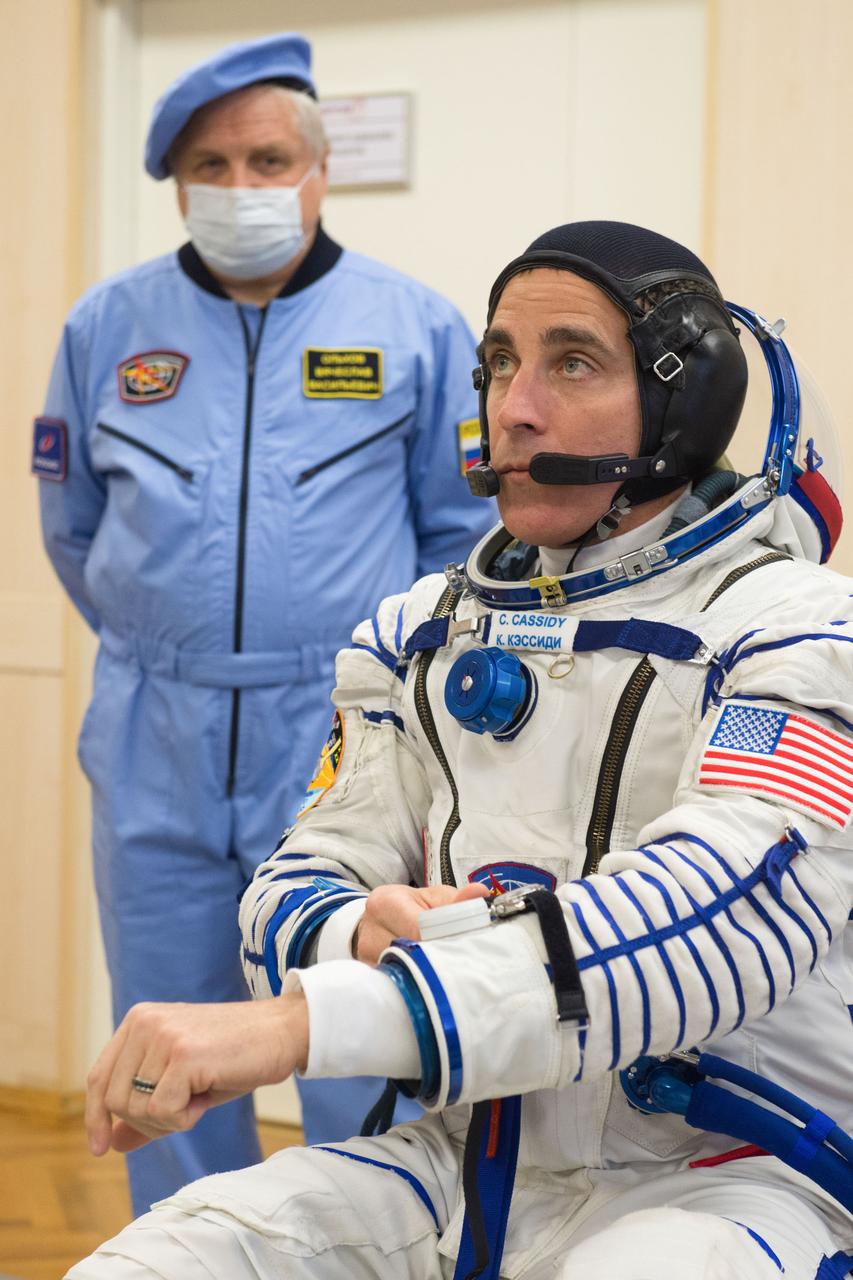 jsc2020e017080 - Expedition 63 Preflight - Expedition 63 crewmember Chris Cassidy of NASA dons his Sokol suit a few hours ahead of his launch on a Soyuz rocket with Ivan Vagner and Anatoly Ivanishin of Roscosmos, Thursday, April 9, 2020 at the Baikonur Cosmodrome in Kazakhstan. A few hours later, they lifted off for a six-and-a-half month mission on the International Space Station. Photo Credit: (NASA/GCTC/Andrey Shelepin)