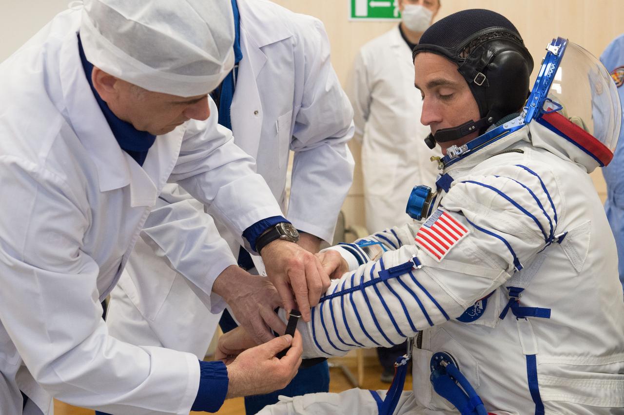 jsc2020e017081 - Expedition 63 Preflight - Expedition 63 crewmember Chris Cassidy of NASA dons his Sokol suit a few hours ahead of his launch on a Soyuz rocket with Ivan Vagner and Anatoly Ivanishin of Roscosmos, Thursday, April 9, 2020 at the Baikonur Cosmodrome in Kazakhstan. A few hours later, they lifted off for a six-and-a-half month mission on the International Space Station. Photo Credit: (NASA/GCTC/Andrey Shelepin)
