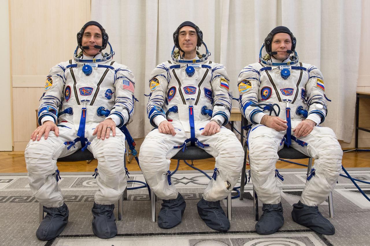 jsc2020e017082 - Expedition 63 Preflight - Expedition 63 crewmember Chris Cassidy of NASA, left, Anatoly Ivanishin of Roscosmos, center, and Ivan Vagner of Roscosmos pose for a group photo after suiting up and preparing for leak checks of their launch and entry suits at the Baikonur Cosmodrome in Kazakhstan as they prepared for launch Thursday, April 9, 2020 on the Soyuz MS-16 spacecraft. A few hours later, they lifted off for a six-and-a-half month mission on the International Space Station. Photo Credit: (NASA/GCTC/Andrey Shelepin)