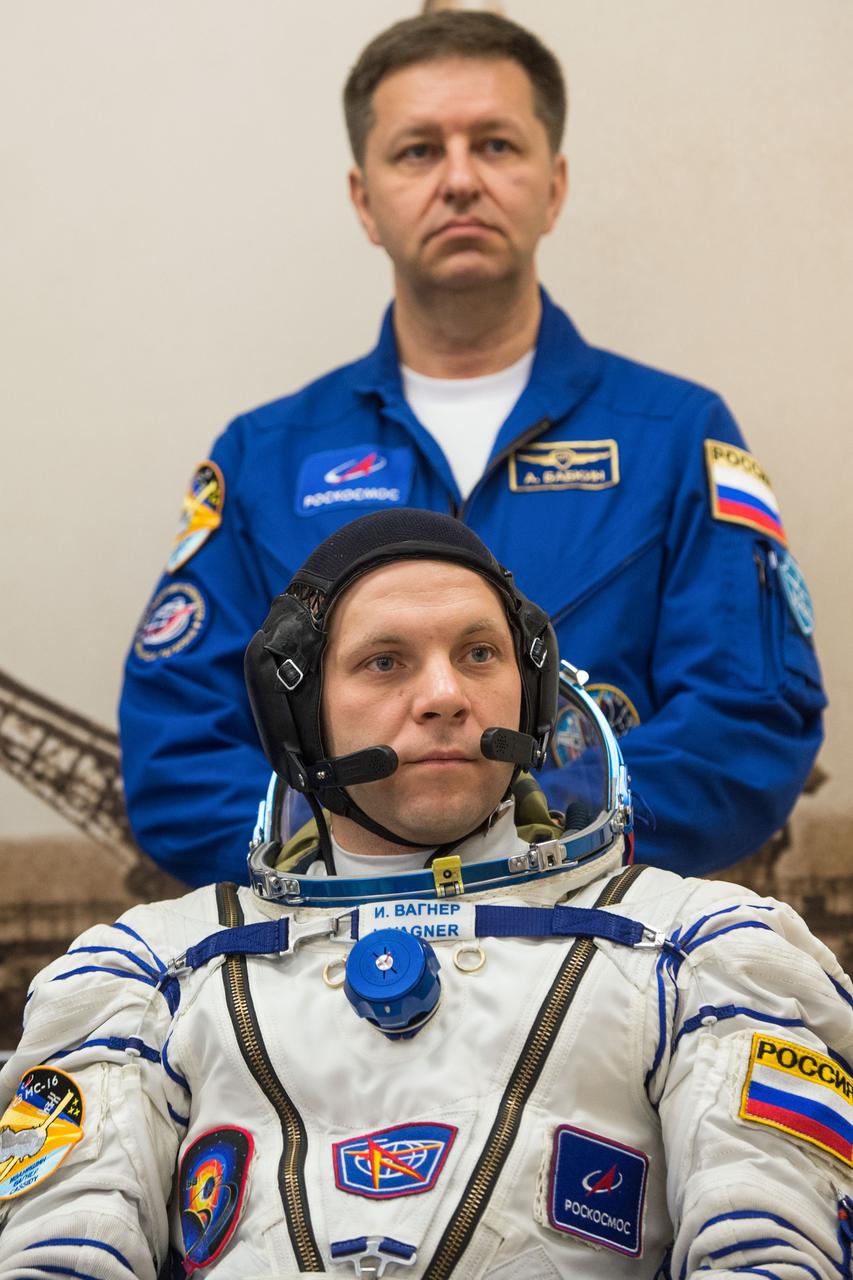 jsc2020e017086 - Expedition 63 Preflight - Expedition 63 crewmember Ivan Vagner of Roscosmos, foreground, waits to have his Sokol suit pressure checked, as backup crew member Andrei Babkin of Roscosmos looks on, Thursday, April 9, 2020 at the Baikonur Cosmodrome in Kazakhstan. A few hours later, Vagner, Anatoly Ivanishin of Roscosmos, and Chris Cassidy of NASA lifted off for a six-and-a-half month mission on the International Space Station. Photo Credit: (NASA/GCTC/Andrey Shelepin)