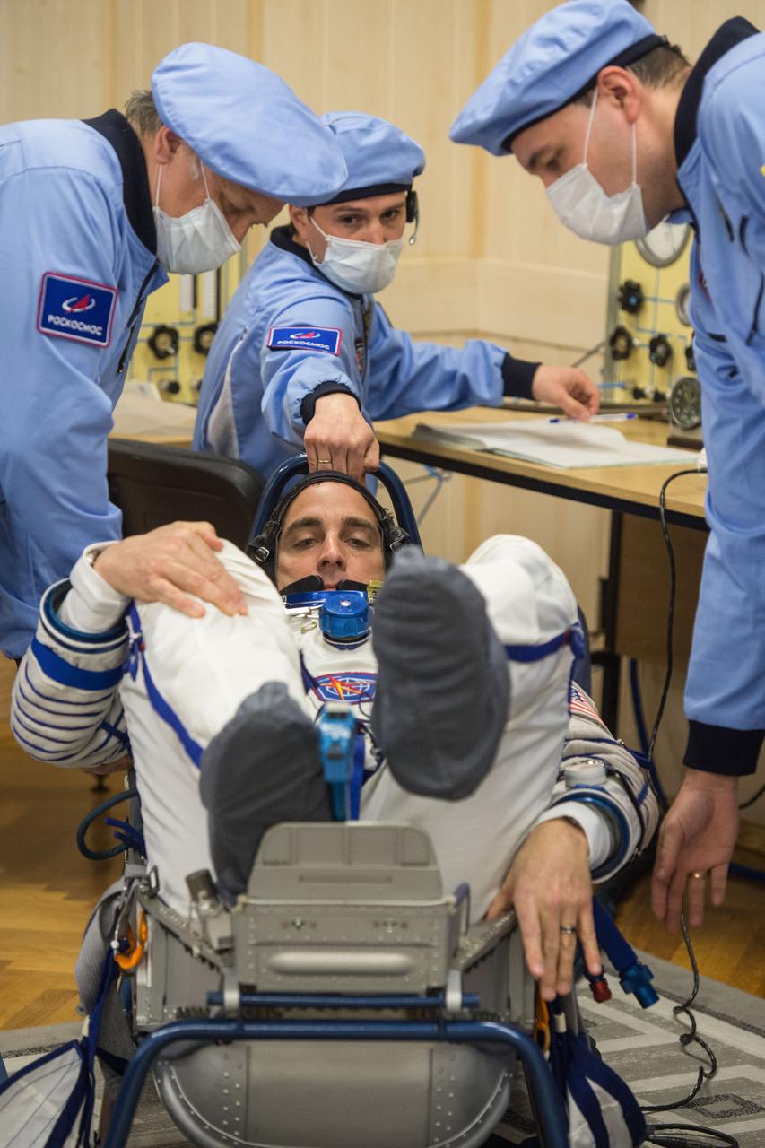 jsc2020e017092 - Expedition 63 Preflight - Expedition 63 crewmember Chris Cassidy of NASA has his Sokol suit pressure checked ahead of his launch on a Soyuz rocket with Anatoly Ivanishin and Ivan Vagner of Roscosmos, Thursday, April 9, 2020 at the Baikonur Cosmodrome in Kazakhstan. A few hours later, Vagner, Anatoly Ivanishin of Roscosmos, and Chris Cassidy of NASA lifted off for a six-and-a-half month mission on the International Space Station. Photo Credit: (NASA/GCTC/Andrey Shelepin)