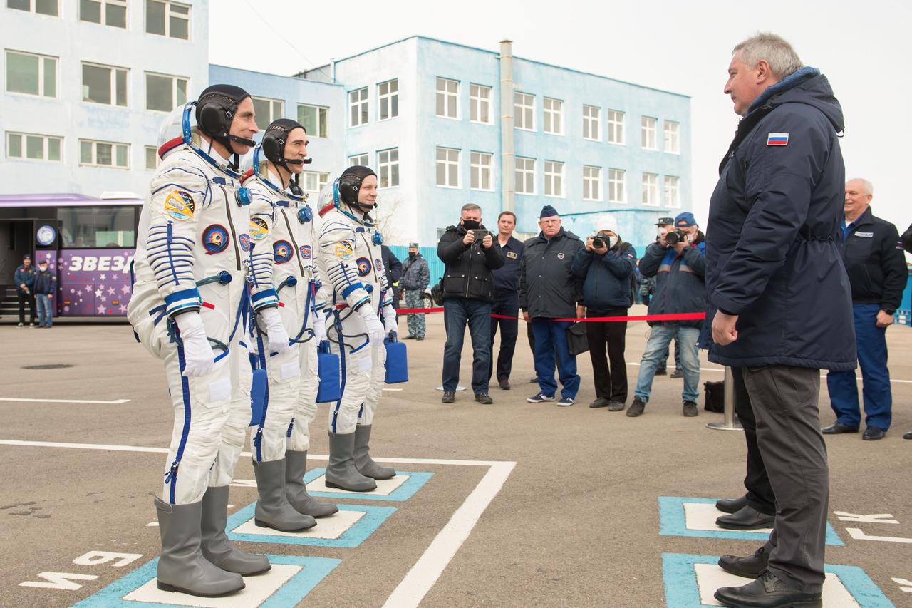 jsc2020e017107 - Expedition 63 Preflight - Expedition 63 crewmembers Chris Cassidy of NASA, left, Anatoly Ivanishin and Ivan Vagner of Roscosmos, report to Roscosmos Director General Dmitry Rogozin, right, as they depart building 254 for the launch pad, Thursday, April 9, 2020 at the Baikonur Cosmodrome in Kazakhstan. A few hours later, they lifted off on a Soyuz rocket for a six-and-a-half month mission on the International Space Station. Photo Credit: (NASA/GCTC/Andrey Shelepin)...