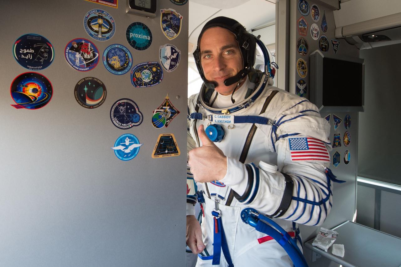 jsc2020e017113 - Expedition 63 Preflight - Expedition 63 crewmember Chris Cassidy of NASA gives a thumbs up onboard the crew bus as he, Anatoly Ivanishin, and Ivan Vagner of Roscosmos arrive at the launch pad, Thursday, April 9, 2020 at the Baikonur Cosmodrome in Kazakhstan. A few hours later, they lifted off on a Soyuz rocket for a six-and-a-half month mission on the International Space Station. Photo Credit: (NASA/GCTC/Andrey Shelepin)...