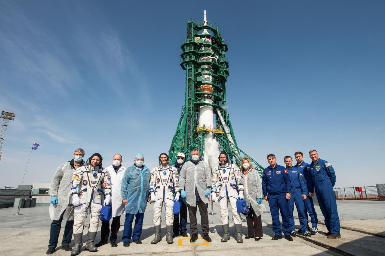 jsc2020e017116 - Expedition 63 Preflight - Expedition 63 crewmembers Ivan Vagner of Roscosmos, Anatoly Ivanishin of Roscosmos, and Chris Cassidy of NASA, pose for a group photograph with Roscosmos Director General Dmitry Rogozin, center, mission management and the backup the crew at the launch pad, Thursday, April 9, 2020 at the Baikonur Cosmodrome in Kazakhstan. A few hours later, the crew lifted off on a Soyuz rocket for a six-and-a-half month mission on the International Space Station. Photo Credit: (NASA/GCTC/Andrey Shelepin)...