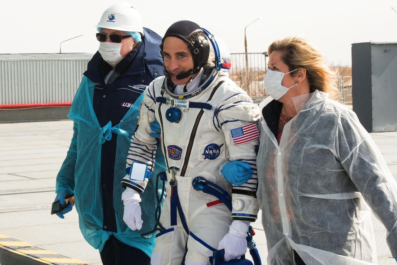 jsc2020e017119 - Expedition 63 Preflight - Expedition 63 crewmember Chris Cassidy of NASA walks to board the Soyuz rocket with NASA Director for Human Space Flight Programs, Russia, Tricia Mack on right, ahead of  launch with Anatoly Ivanishin and Ivan Vagner of Roscosmos, Thursday, April 9, 2020 at the Baikonur Cosmodrome in Kazakhstan. A few hours later, the trio lifted off on a Soyuz rocket for a six-and-a-half month mission on the International Space Station. Photo Credit: (NASA/GCTC/Andrey Shelepin)...